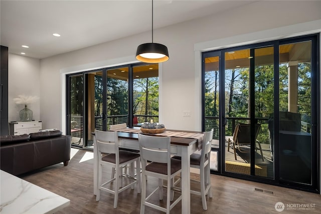 dining area featuring recessed lighting, wood finished floors, and a healthy amount of sunlight