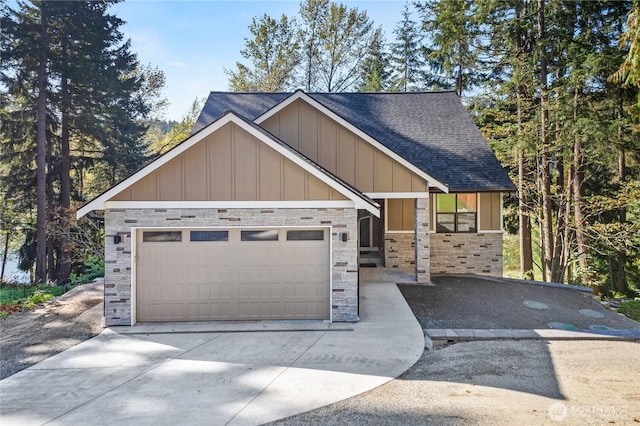 view of front of property with board and batten siding, driveway, roof with shingles, and a garage