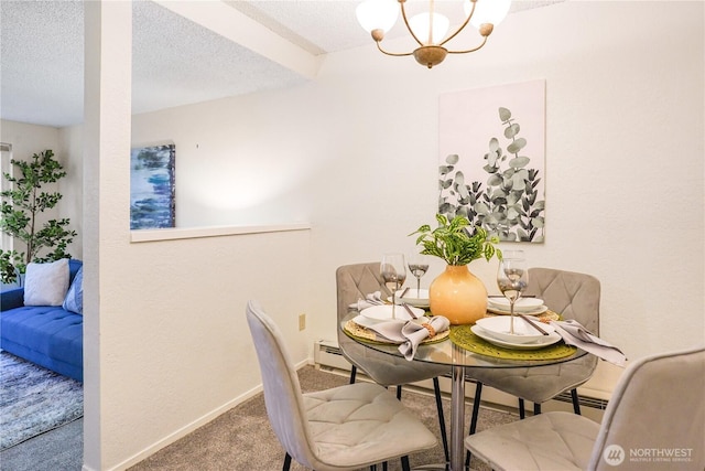 carpeted dining area featuring baseboards, a notable chandelier, and a textured ceiling