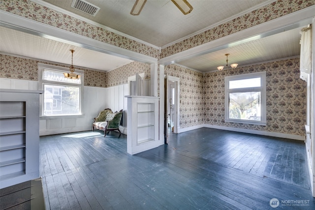 2231 Highland Ave, Everett, WA 98201 - unfurnished living room featuring visible vents, ceiling fan with notable chandelier, ornamental molding, wallpapered walls, and dark wood-type flooring