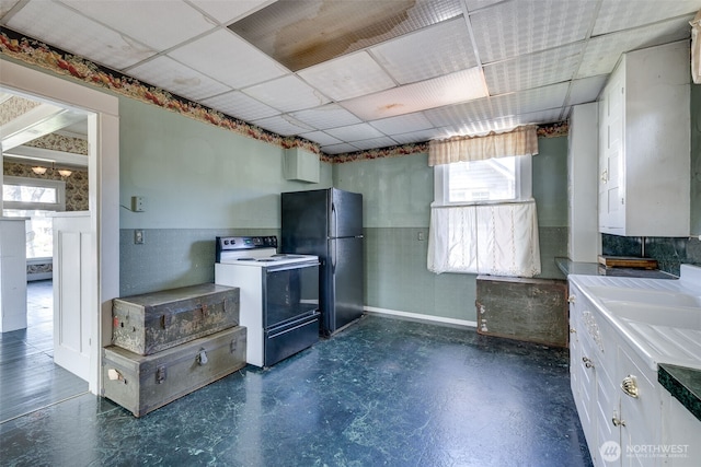2231 Highland Ave, Everett, WA 98201 - kitchen with light countertops, freestanding refrigerator, electric stove, a drop ceiling, and white cabinetry