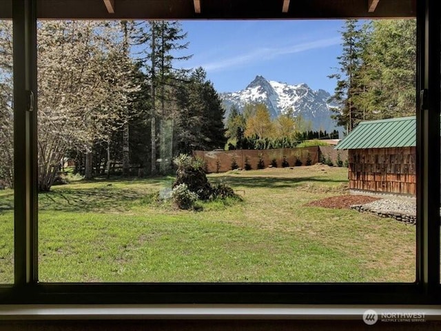 view of yard with fence and a mountain view
