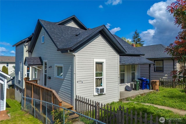rear view of house featuring a fenced backyard, a patio, cooling unit, and a shingled roof
