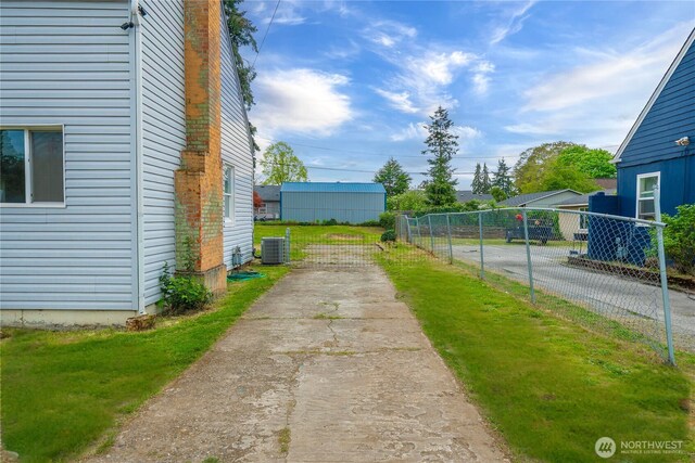 exterior space with fence, driveway, and cooling unit