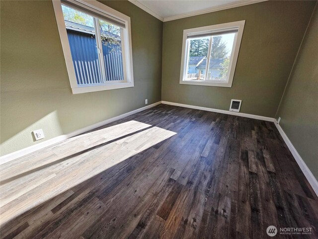 6818 Olympic Hwy, Aberdeen, WA 98520 - unfurnished room featuring dark wood finished floors, a healthy amount of sunlight, crown molding, and baseboards