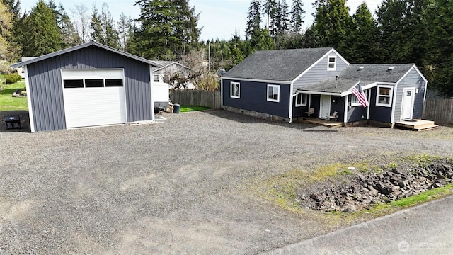 6818 Olympic Hwy, Aberdeen, WA 98520 - view of front of home with fence, gravel driveway, an outbuilding, and a garage