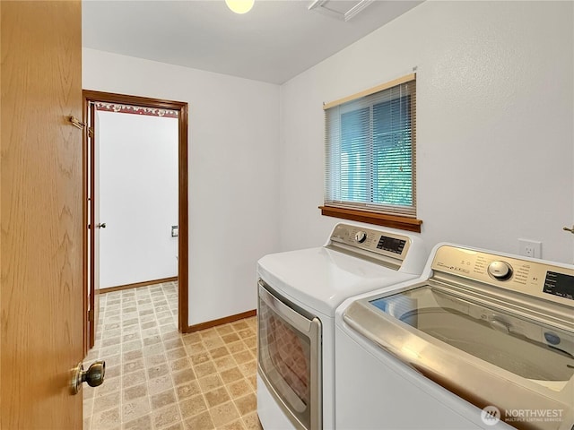 clothes washing area with separate washer and dryer, baseboards, and light flooring