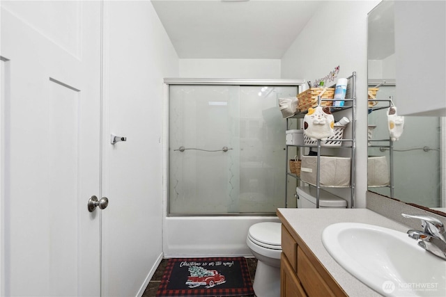 bathroom featuring toilet, vanity, and enclosed tub / shower combo