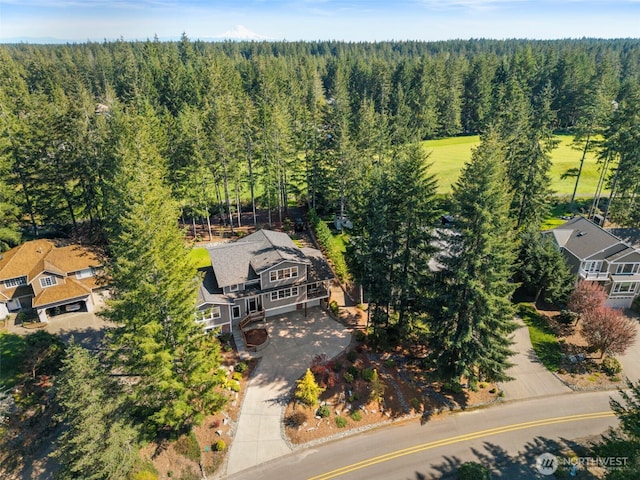 birds eye view of property with a wooded view