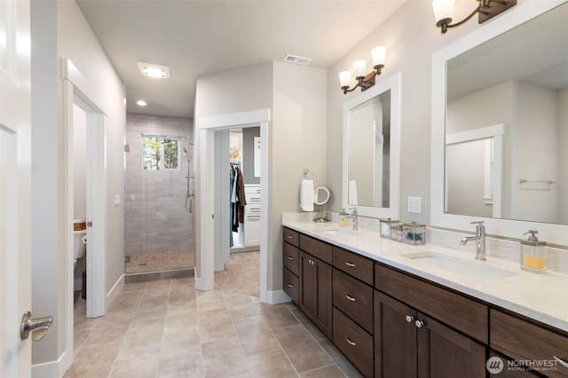full bathroom featuring tile patterned flooring, a sink, a shower stall, and toilet
