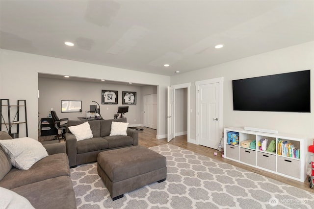 living area with baseboards, wood finished floors, and recessed lighting