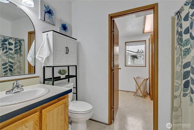 bathroom with vanity and toilet