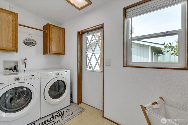 laundry room featuring cabinet space, washer and dryer, and light flooring