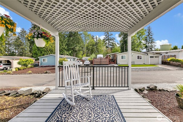 view of patio featuring a garage and fence