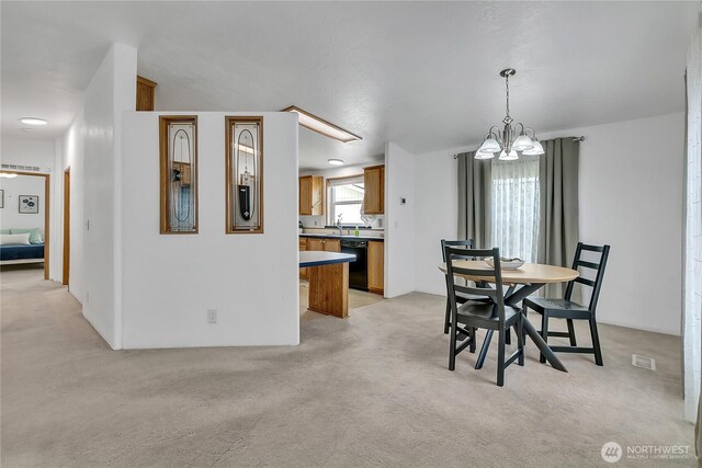 dining space with light colored carpet and a chandelier