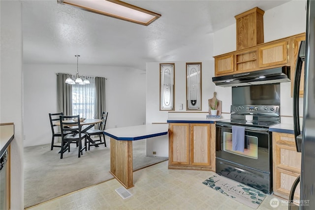 kitchen with black appliances, under cabinet range hood, a peninsula, light countertops, and light colored carpet