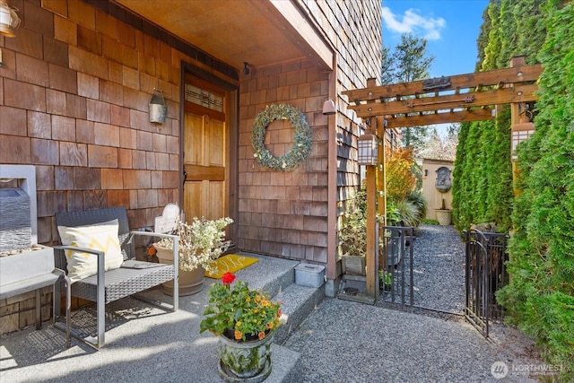 property entrance with a pergola