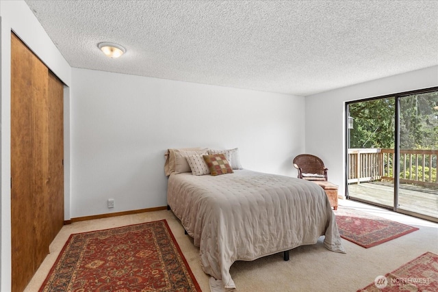 bedroom featuring light colored carpet, access to outside, and a textured ceiling