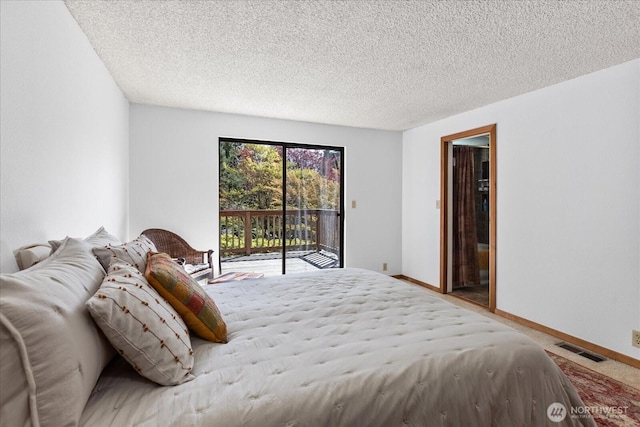 bedroom featuring baseboards, visible vents, access to outside, and a textured ceiling