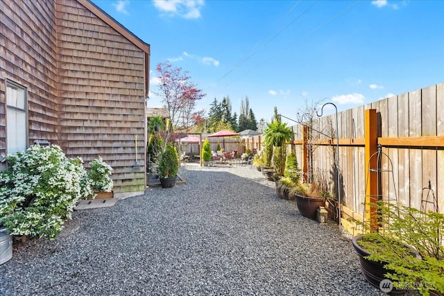 view of yard featuring a patio and a fenced backyard