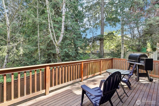 wooden terrace with a grill