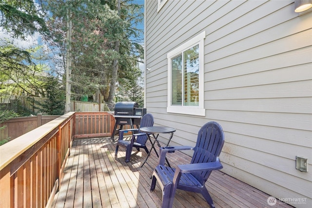 wooden terrace featuring fence