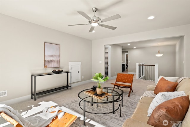 carpeted living room with visible vents, baseboards, ceiling fan, and recessed lighting