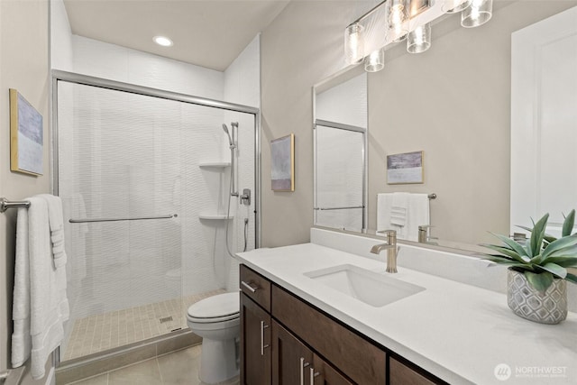bathroom with toilet, vanity, recessed lighting, tile patterned floors, and a shower stall