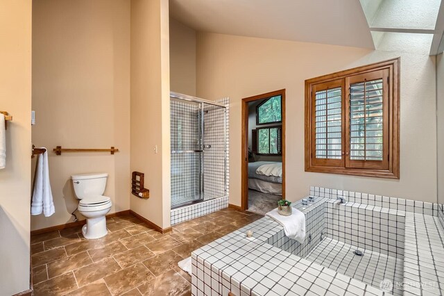 full bath featuring a shower stall, toilet, baseboards, ensuite bathroom, and high vaulted ceiling