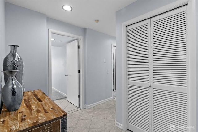 hallway with baseboards, a heating unit, and recessed lighting