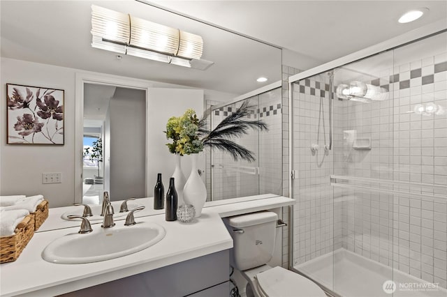 full bathroom featuring a stall shower, toilet, vanity, and recessed lighting
