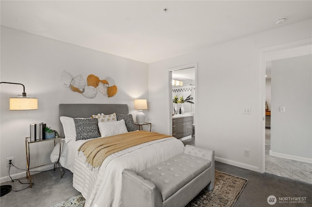 carpeted bedroom with connected bathroom and baseboards