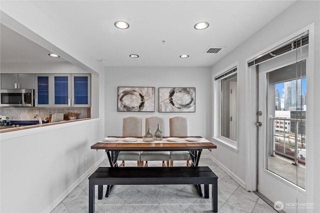 dining room featuring baseboards, marble finish floor, visible vents, and recessed lighting