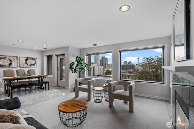 living area featuring baseboards, marble finish floor, and recessed lighting