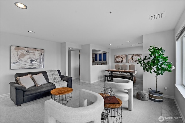 living area with baseboards, recessed lighting, and visible vents