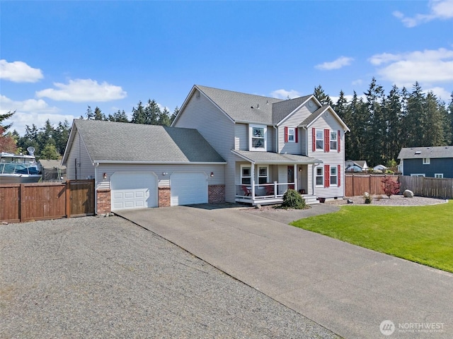 view of front facade featuring aphalt driveway, fence, a front lawn, an attached garage, and covered porch