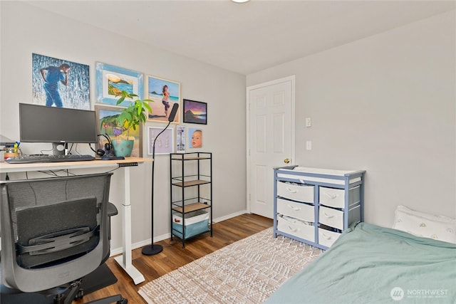 bedroom with baseboards and wood finished floors