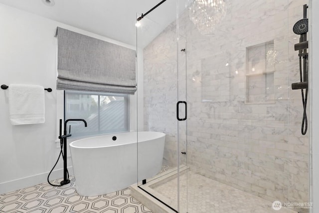 full bath featuring a shower stall, baseboards, and a soaking tub