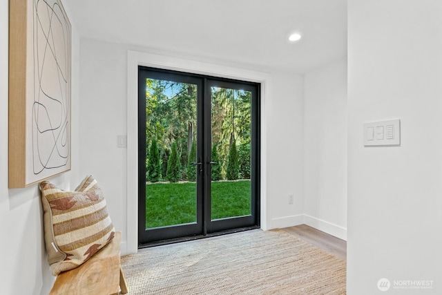 doorway to outside with baseboards, wood finished floors, and recessed lighting