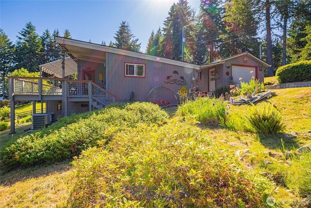 71 E Mountain Dr, Grapeview, WA 98546 - view of front of house featuring stairway, a wooden deck, central AC unit, and an attached garage