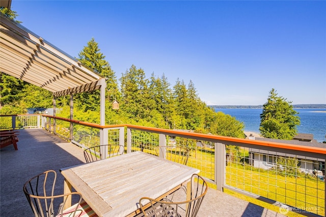 71 E Mountain Dr, Grapeview, WA 98546 - wooden terrace featuring a water view, a pergola, a lawn, and outdoor dining space