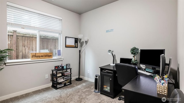 home office with carpet floors and baseboards