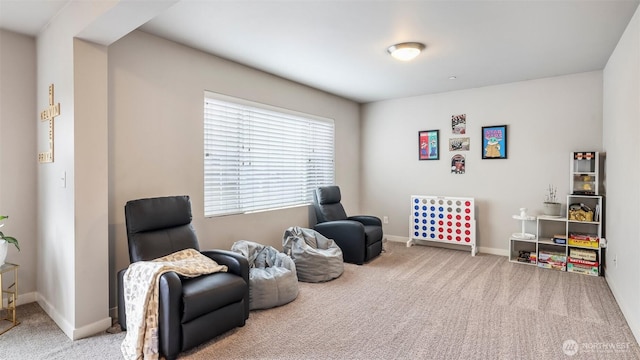 sitting room with baseboards and carpet flooring