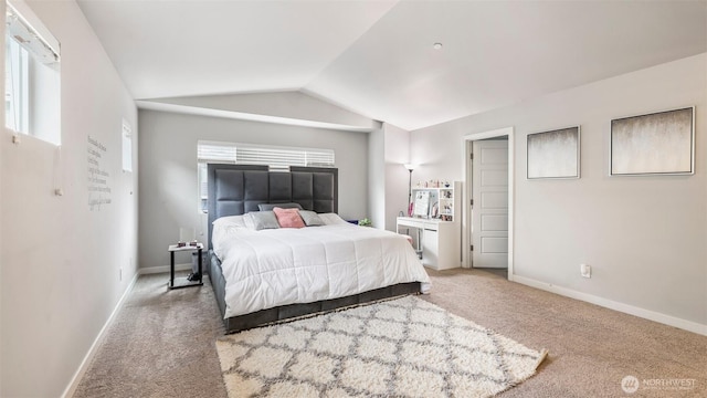 carpeted bedroom featuring lofted ceiling and baseboards