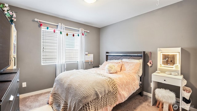 bedroom with baseboards and carpet