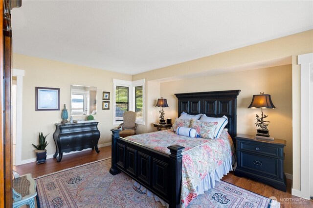 bedroom featuring baseboards and wood finished floors