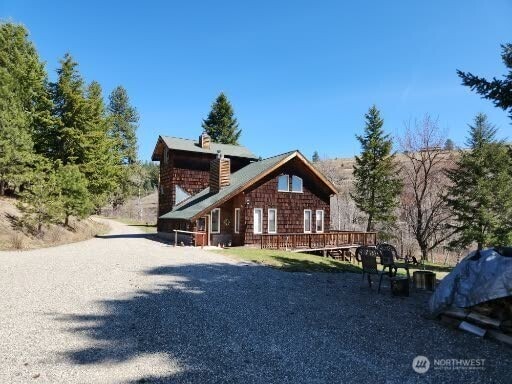 rear view of property with a wooden deck and a chimney