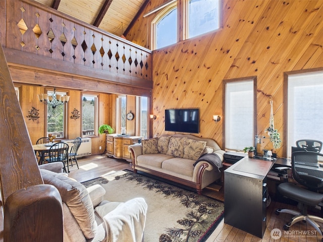 living room with wood-type flooring, plenty of natural light, high vaulted ceiling, and wooden ceiling