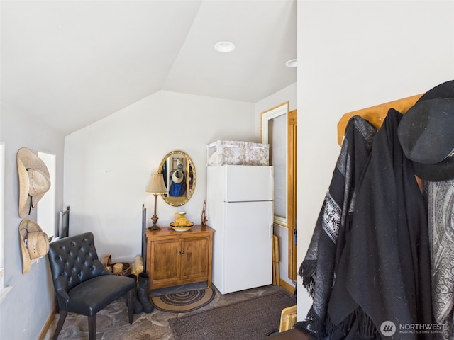 living area featuring lofted ceiling and carpet floors