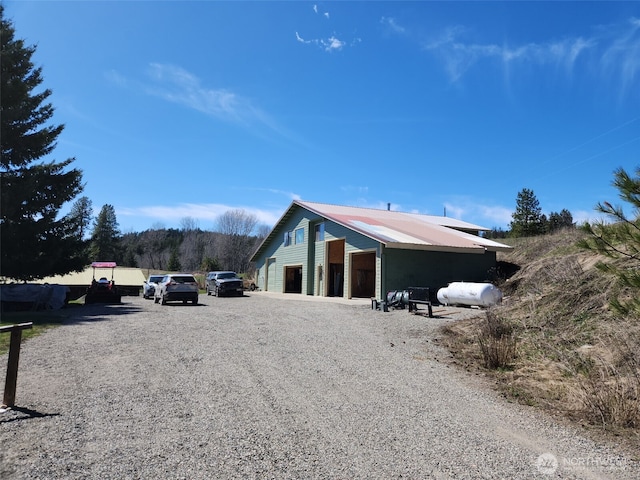 exterior space featuring a garage and metal roof